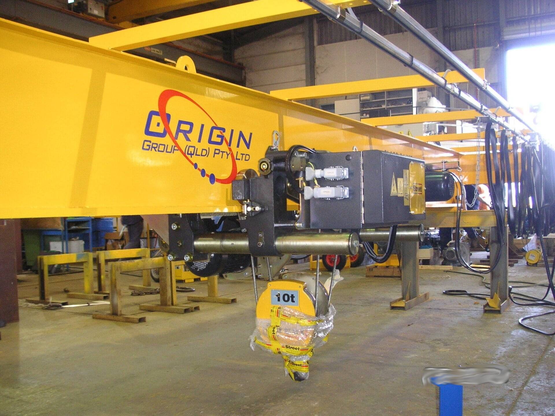 A Yellow Crane With The Word Origin On It — Origin Group in Paget, QLD