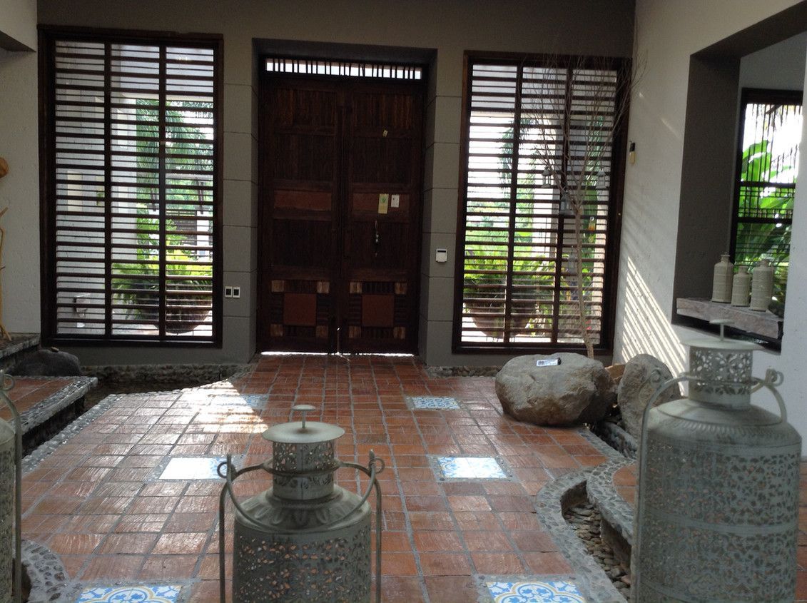 A room with a brick floor and a large door