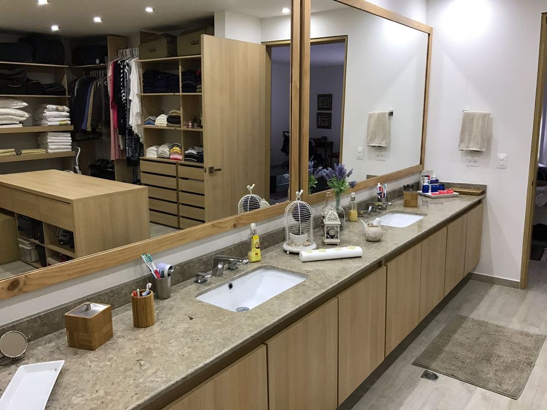 A bathroom with two sinks and a large mirror.