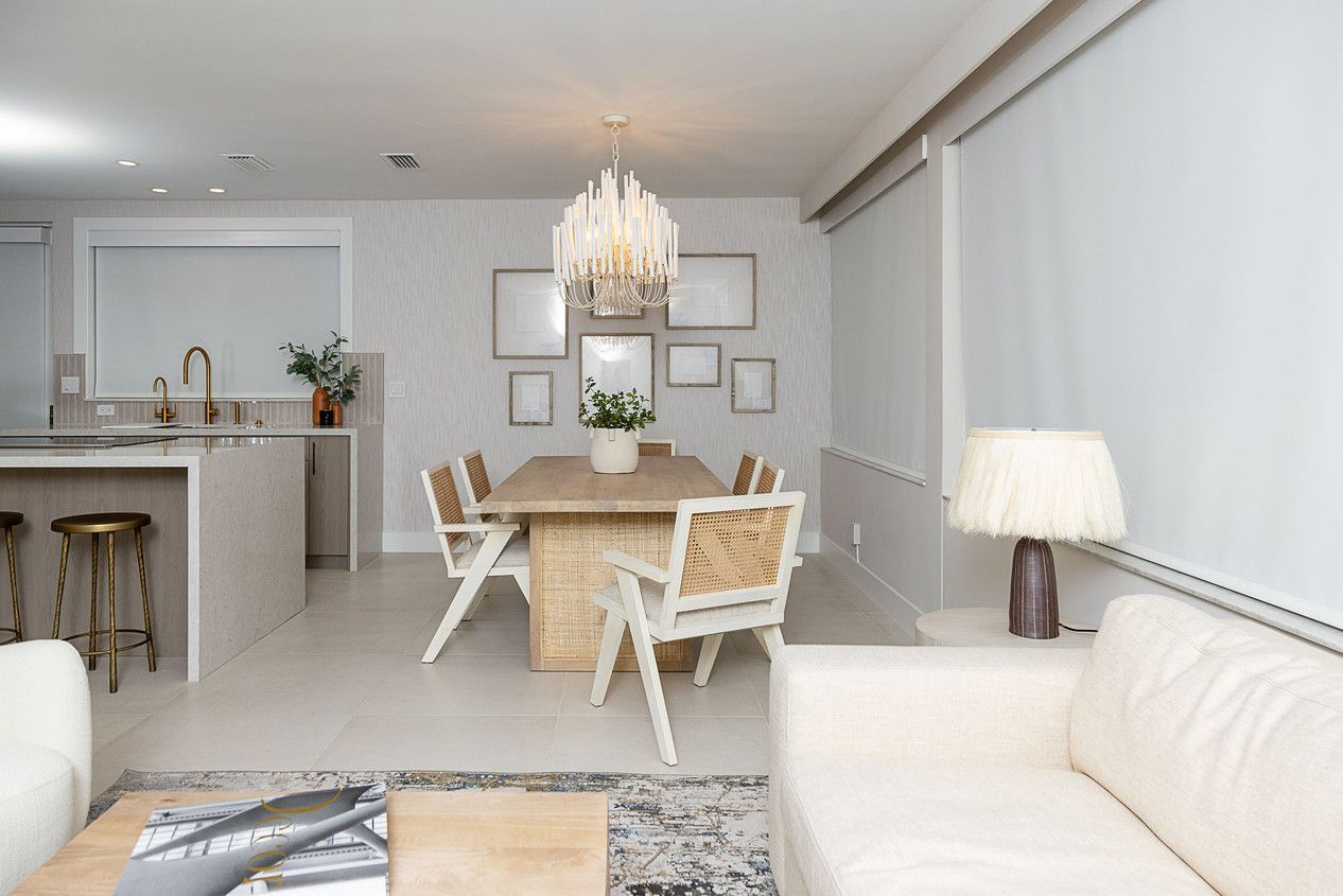 A living room with a couch a table and chairs