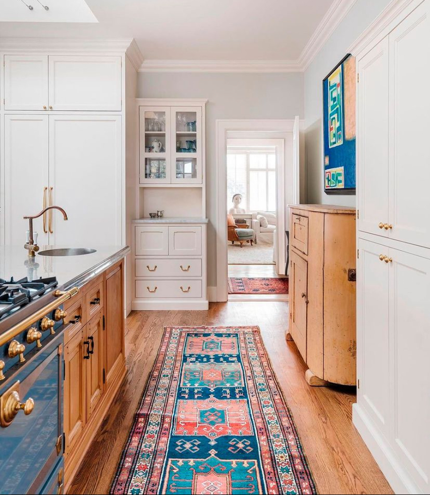 A kitchen with a rug that says peace on it