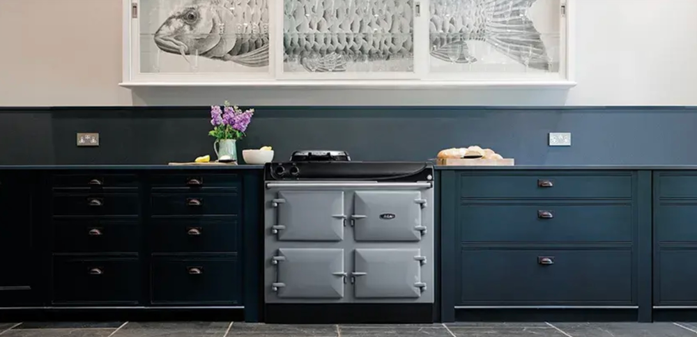 A kitchen with blue cabinets and a silver stove top oven.