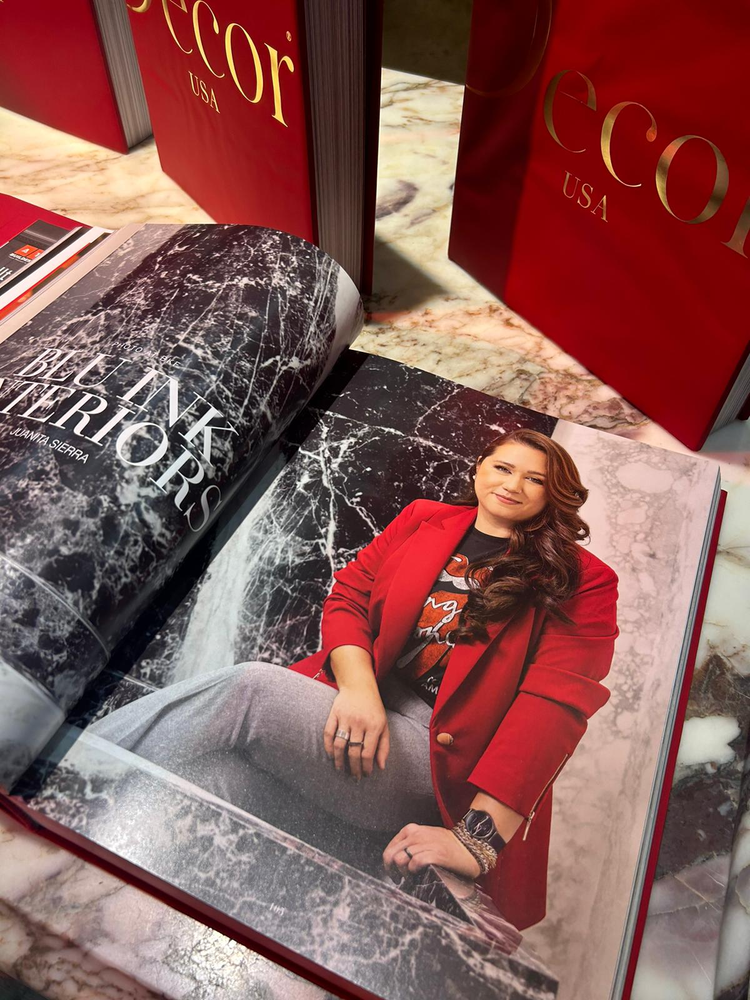 A woman in a red jacket is sitting in front of a waterfall in a book.