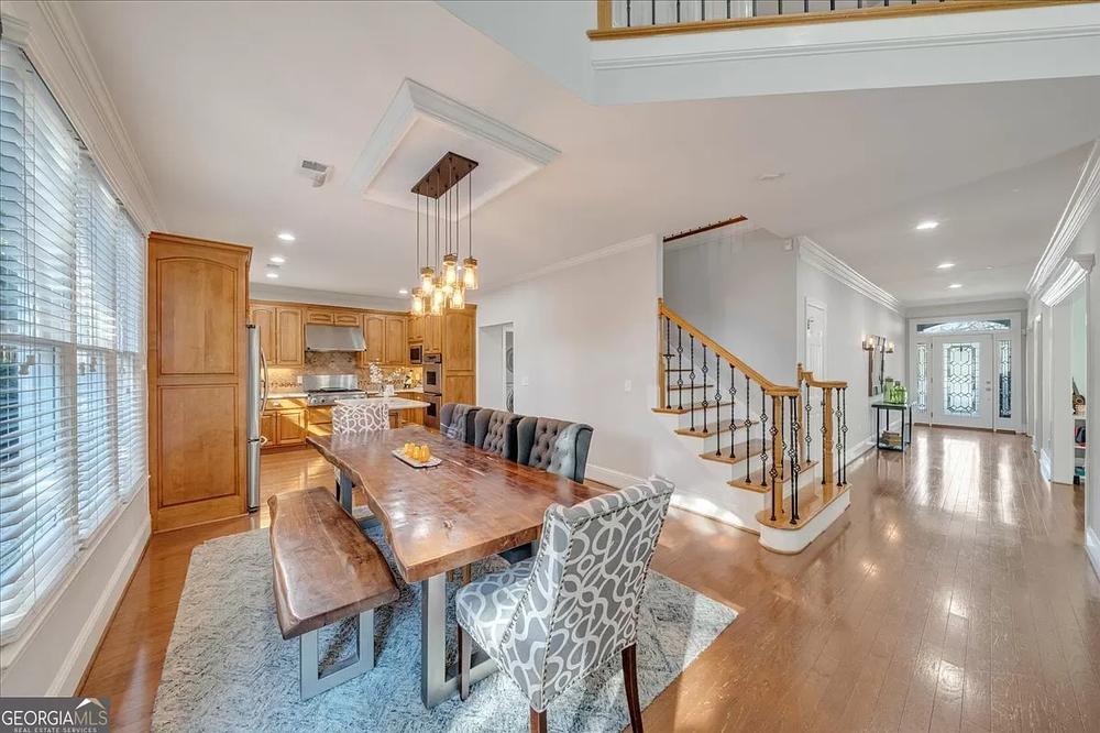 There is a dining room table and chairs in the middle of the room.