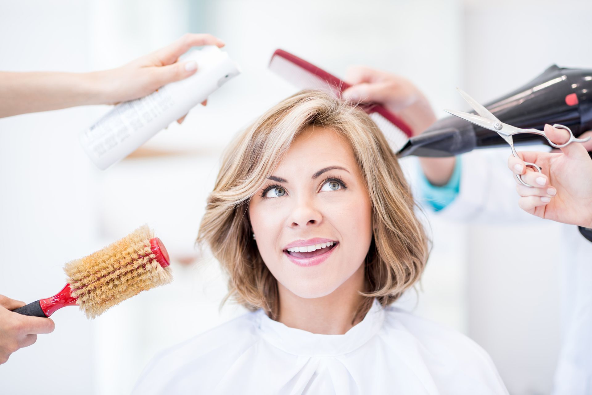 A woman is getting her haircut at a salon