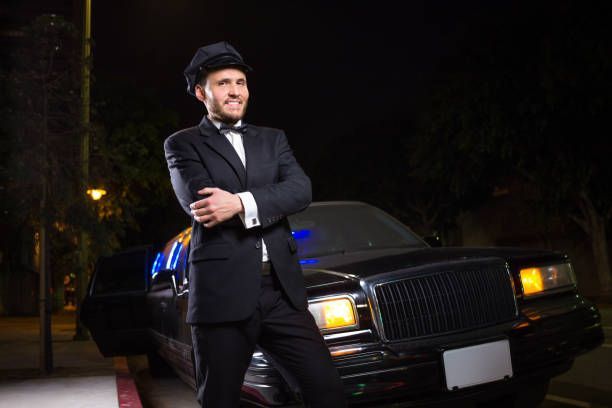 A man in a suit and tie stands beside a luxury limo, representing 5-Star Limo Rental services.