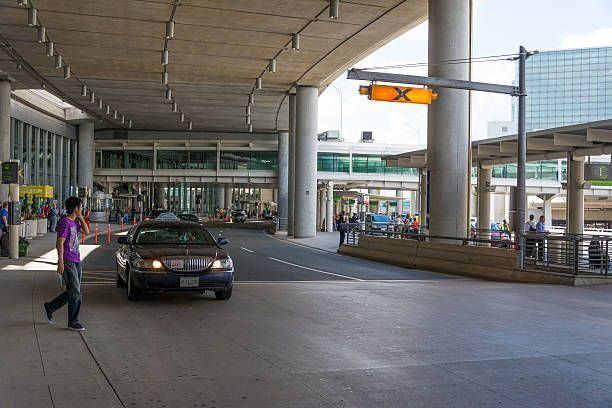 A woman walks across a parking lot near a car, representing Airport Limo Transportation services.