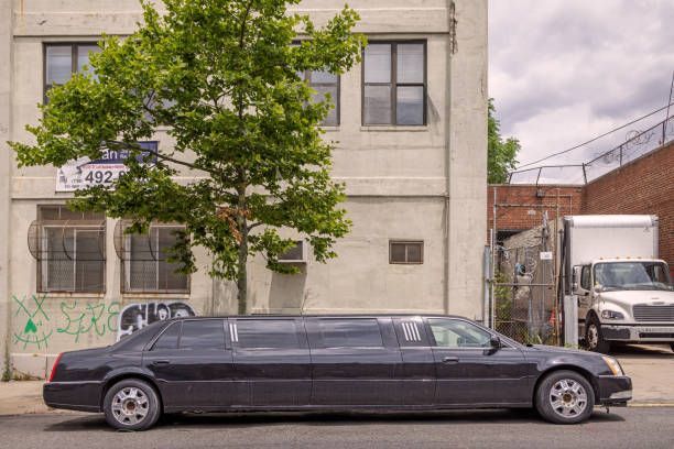 A black limousine parked in front of a building, indicating a limo rental service.