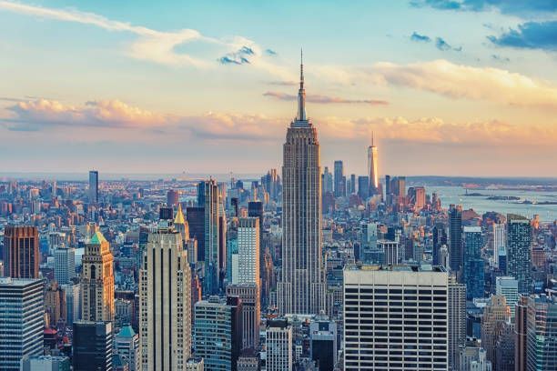 An aerial view of the skyline of new york city at sunset.