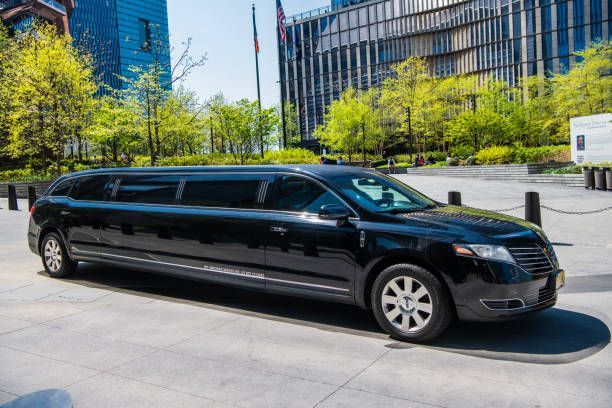 A black limousine parked in front of a building, indicating airport limo transportation services available.