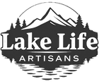 A black and white logo for lake life artisans with mountains and trees.