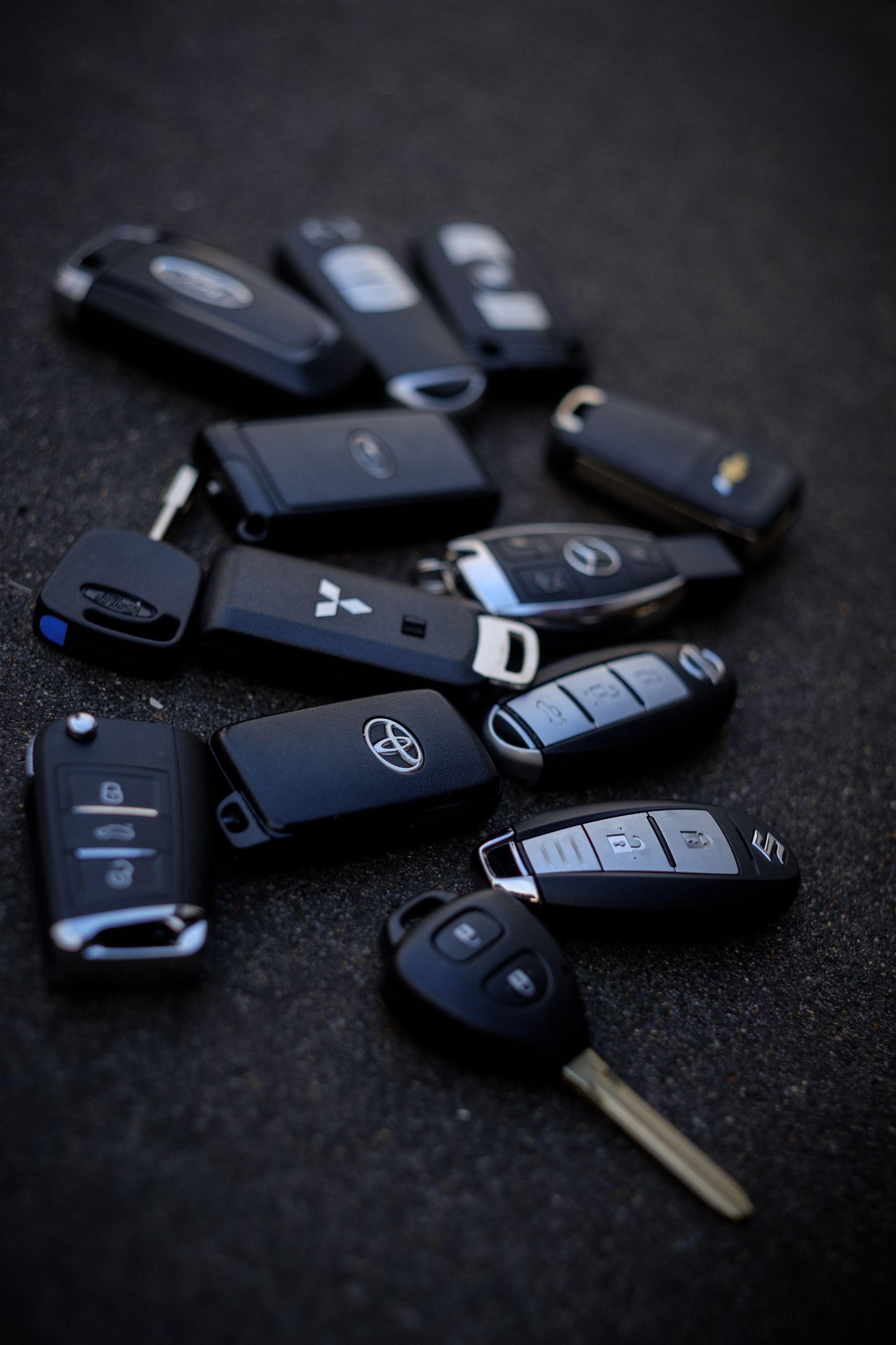 A car key is sitting in front of a toy car