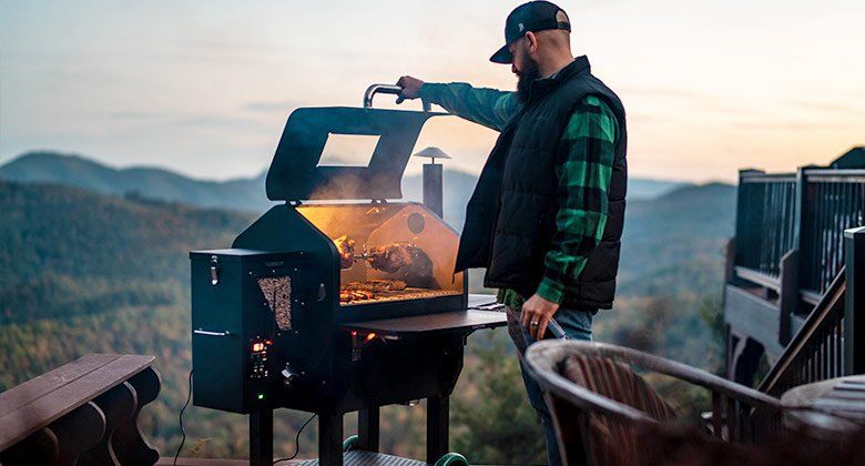 Man cooking with Green Mountain Grill