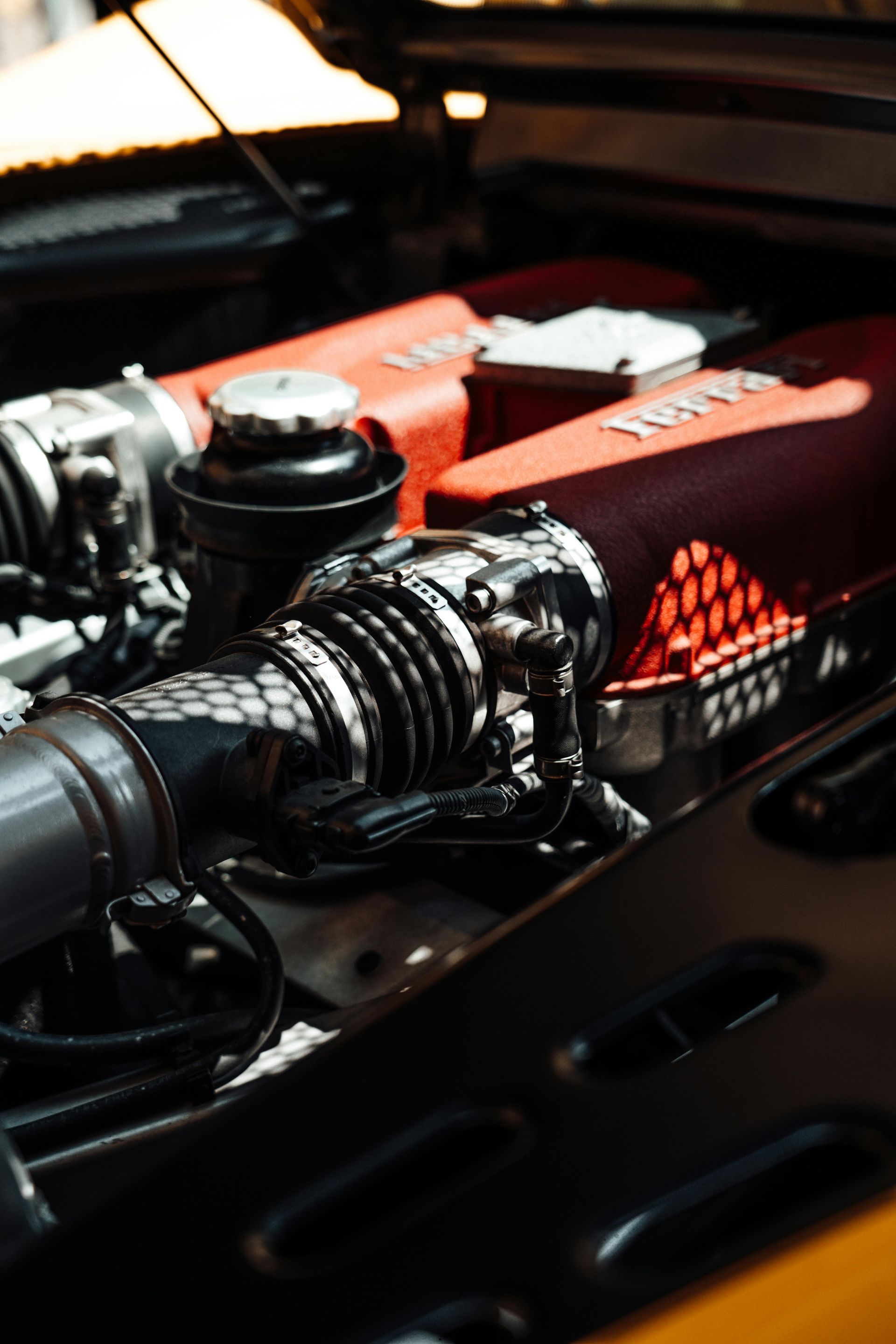 A close up of a car engine with the hood open.