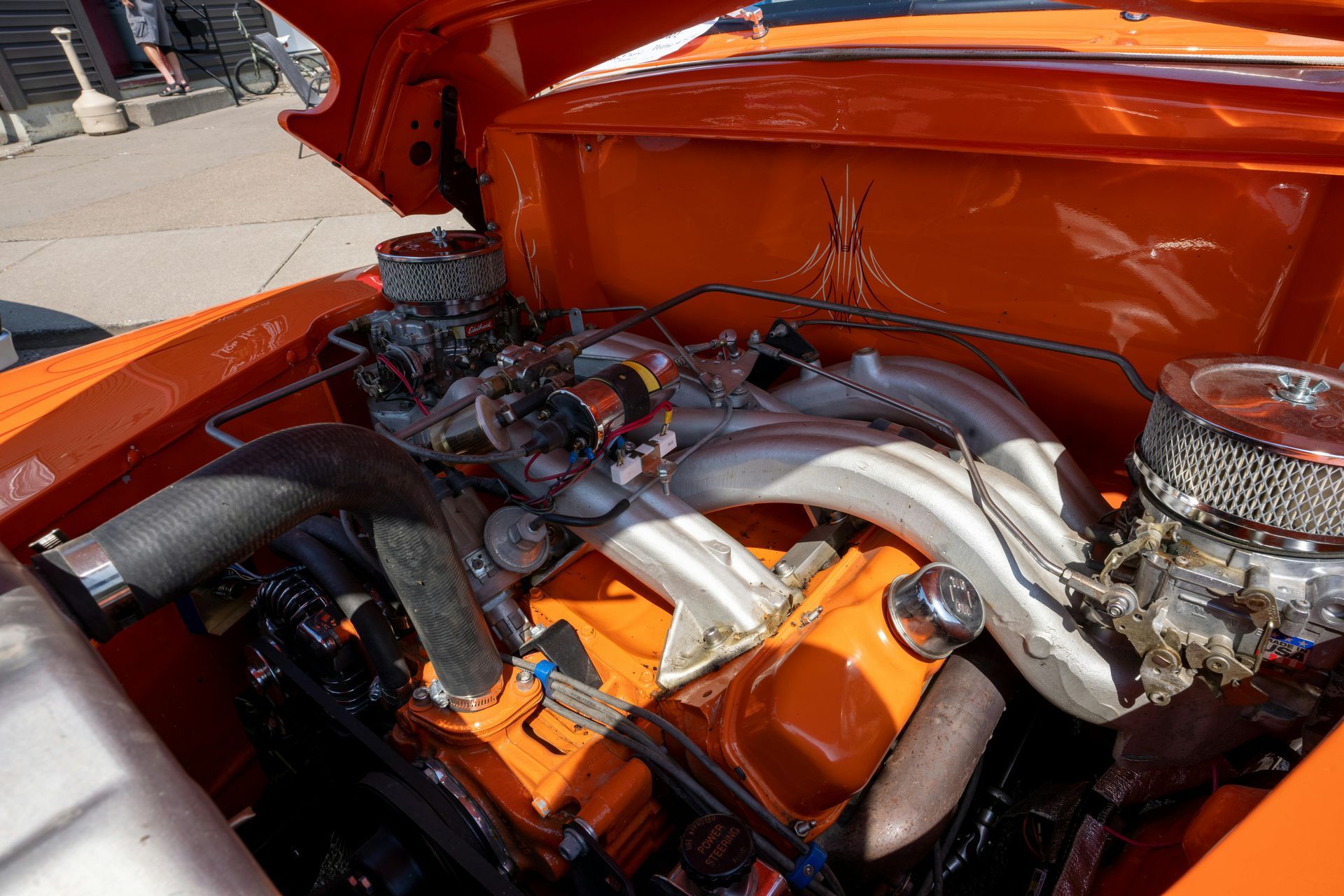 A close up of a car engine with the hood up