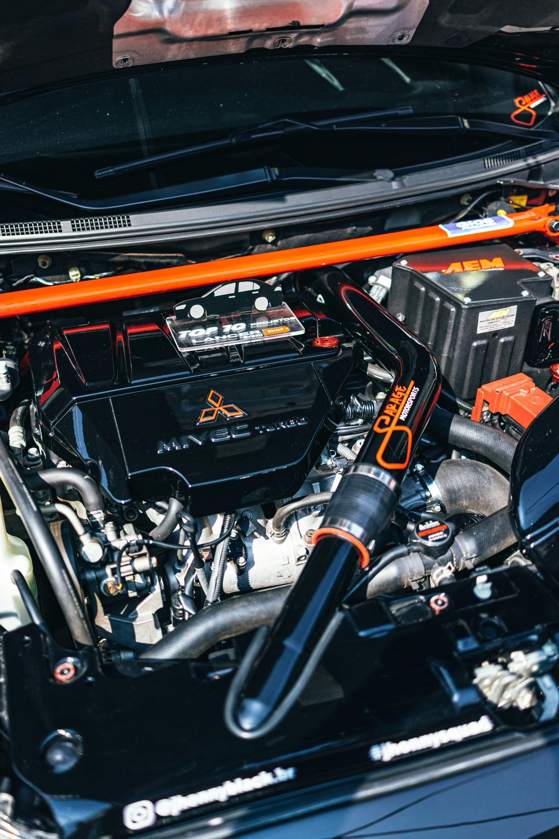 A close up of a car engine with the hood open