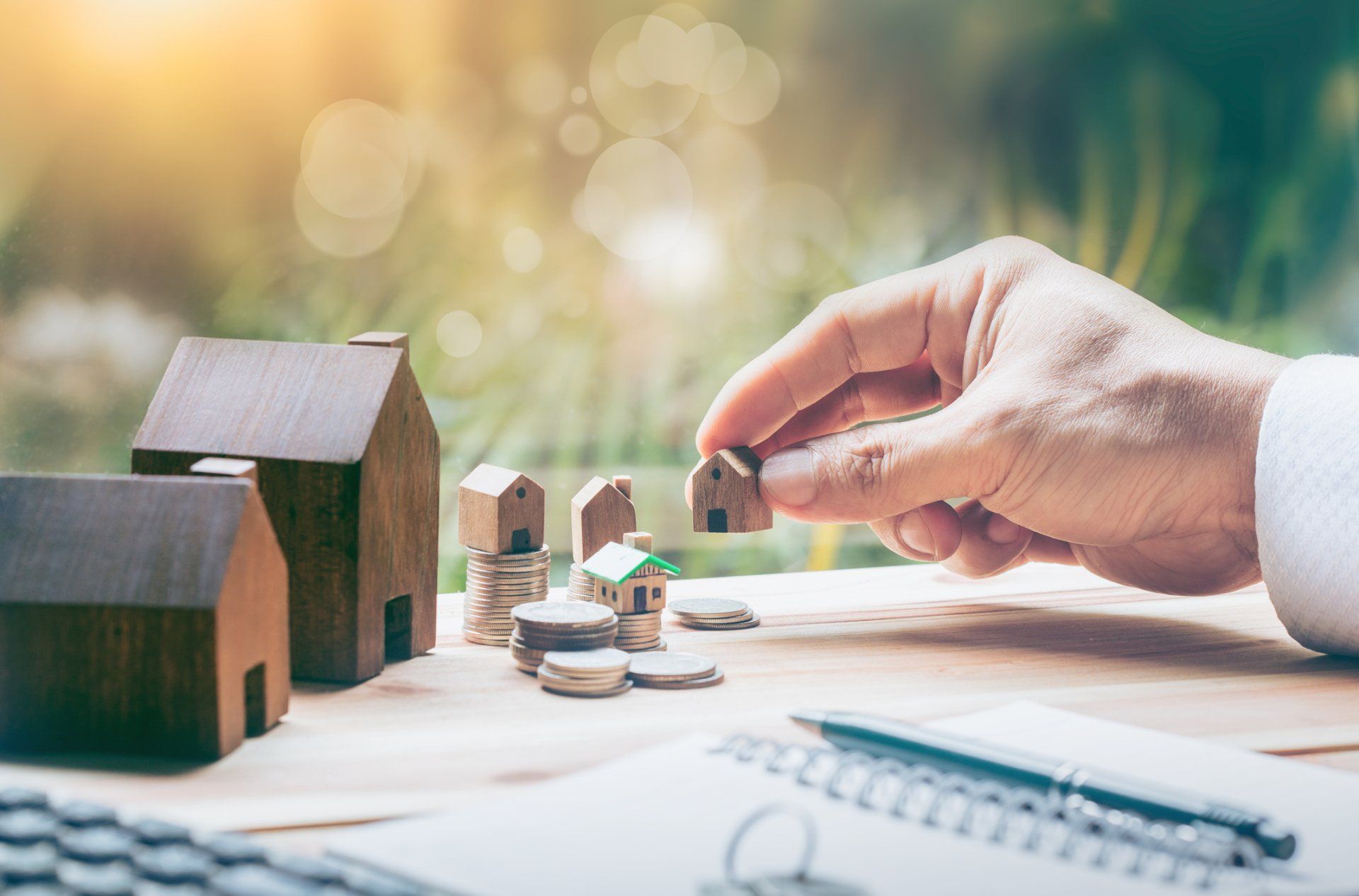 investor with coins and wooden houses