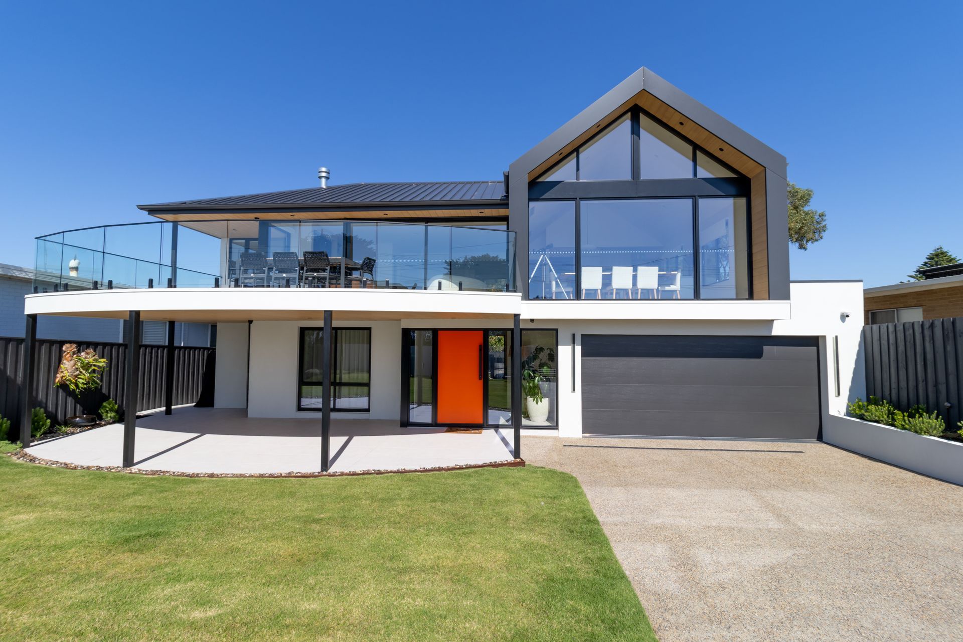 A large house with a garage and a balcony | Building Services | Coastyle