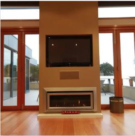 A fireplace with a flat screen tv above it | Building Services | Coastyle