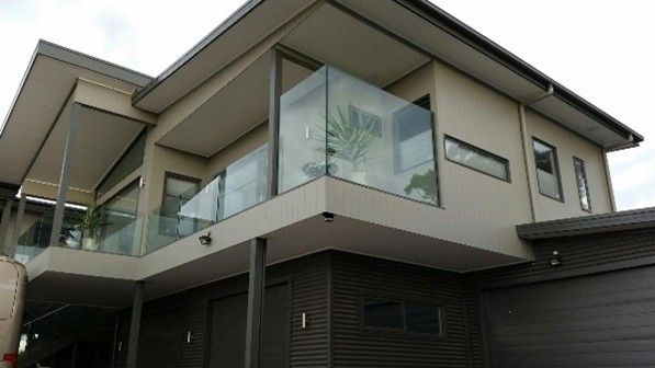 View of a sleek two-storey home with a balcony, showcasing a custom home renovation.