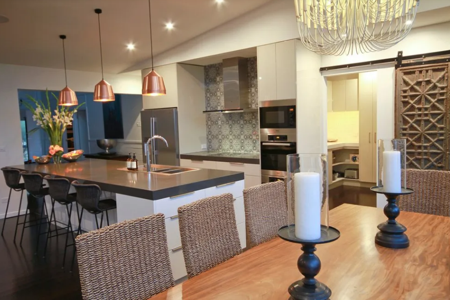 A dining room table with candles on it in a kitchen | Building Services | Coastyle