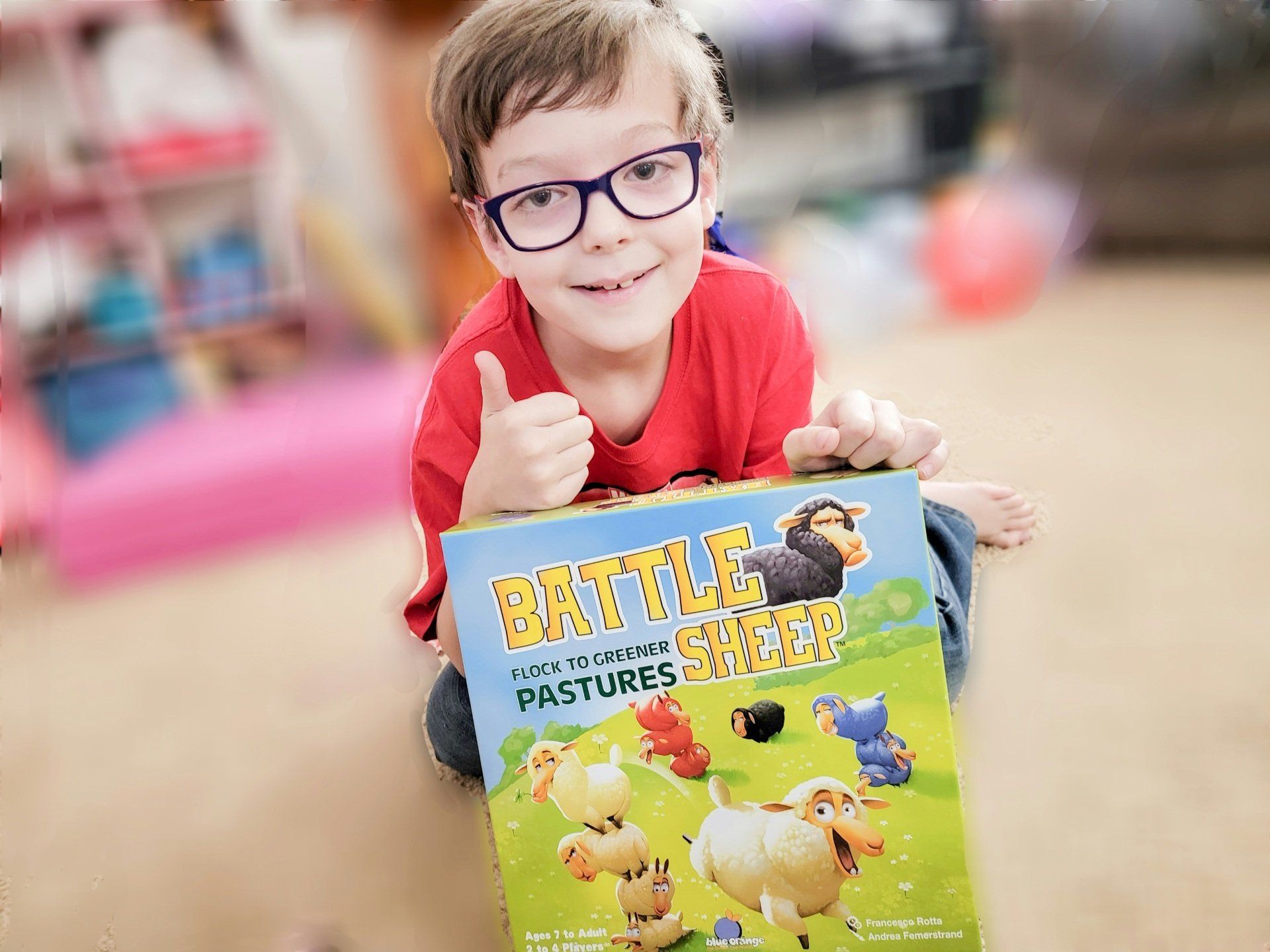 Alvin Jr from Homeschool Family Stuff holding the Battle Sheep game from Timberdoodle
