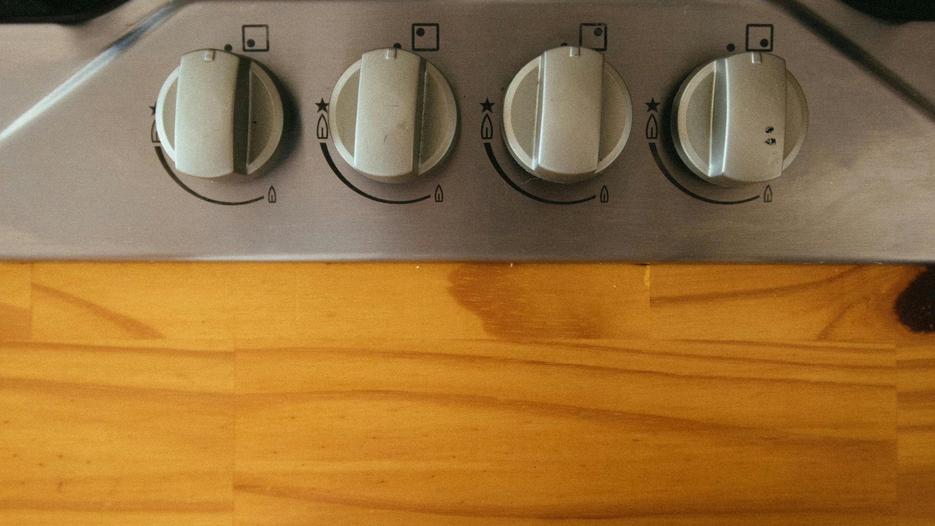 A close up of a stove top oven on a wooden table.