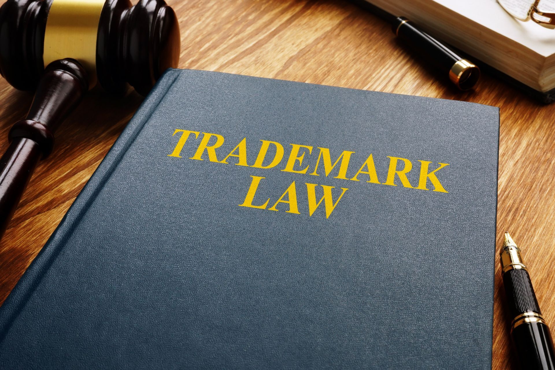 A book titled trademark law is on a wooden table