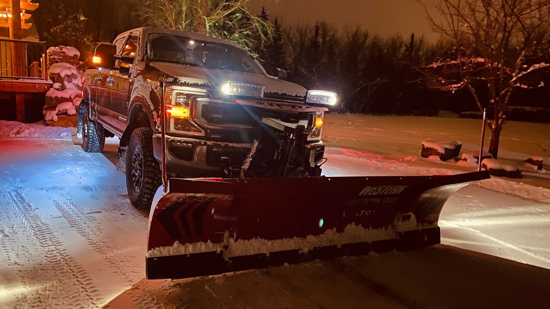 a person is using a snow blower on a snowy sidewalk