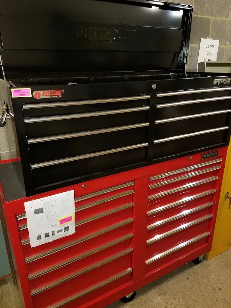 A red toolbox with a black toolbox on top of it.
