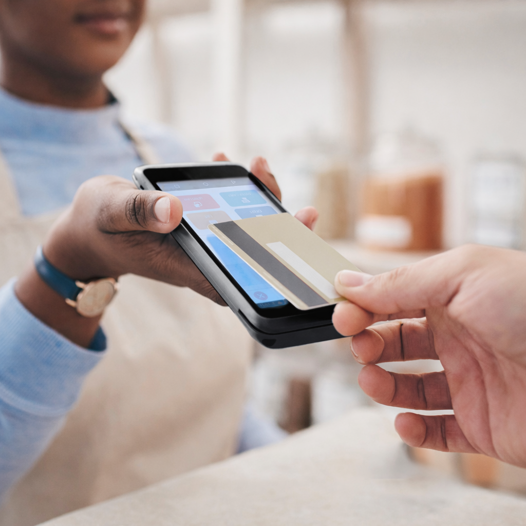 Two point-of-sale terminals and a smartphone with a check mark, on a blue background.