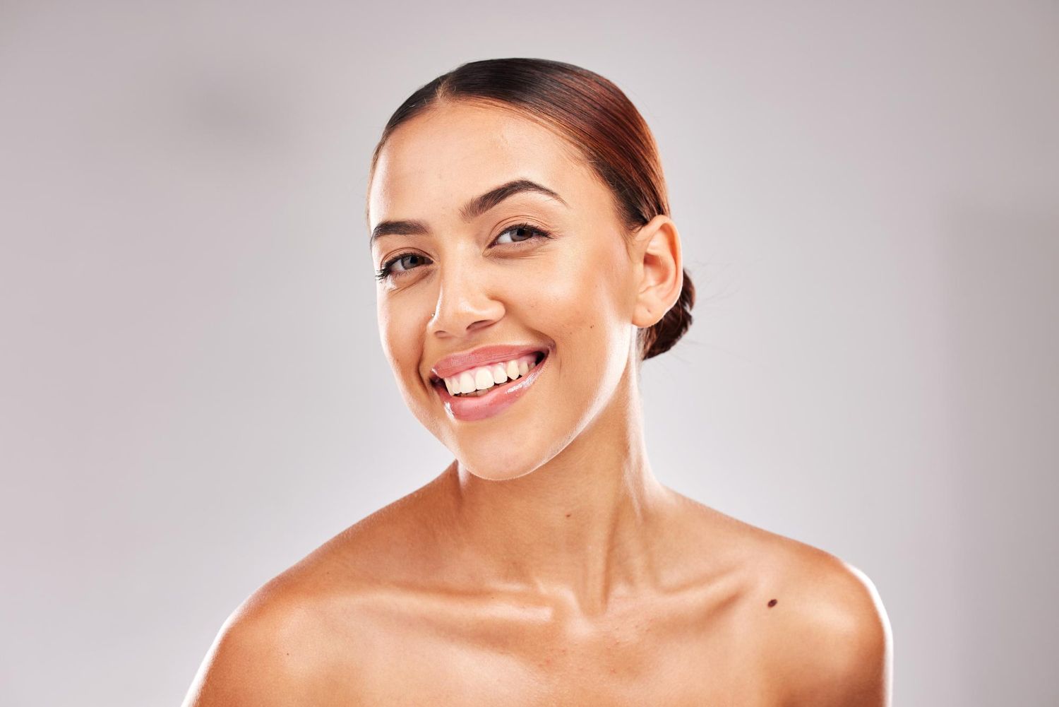 A close up of a woman 's face with a smile on her face.