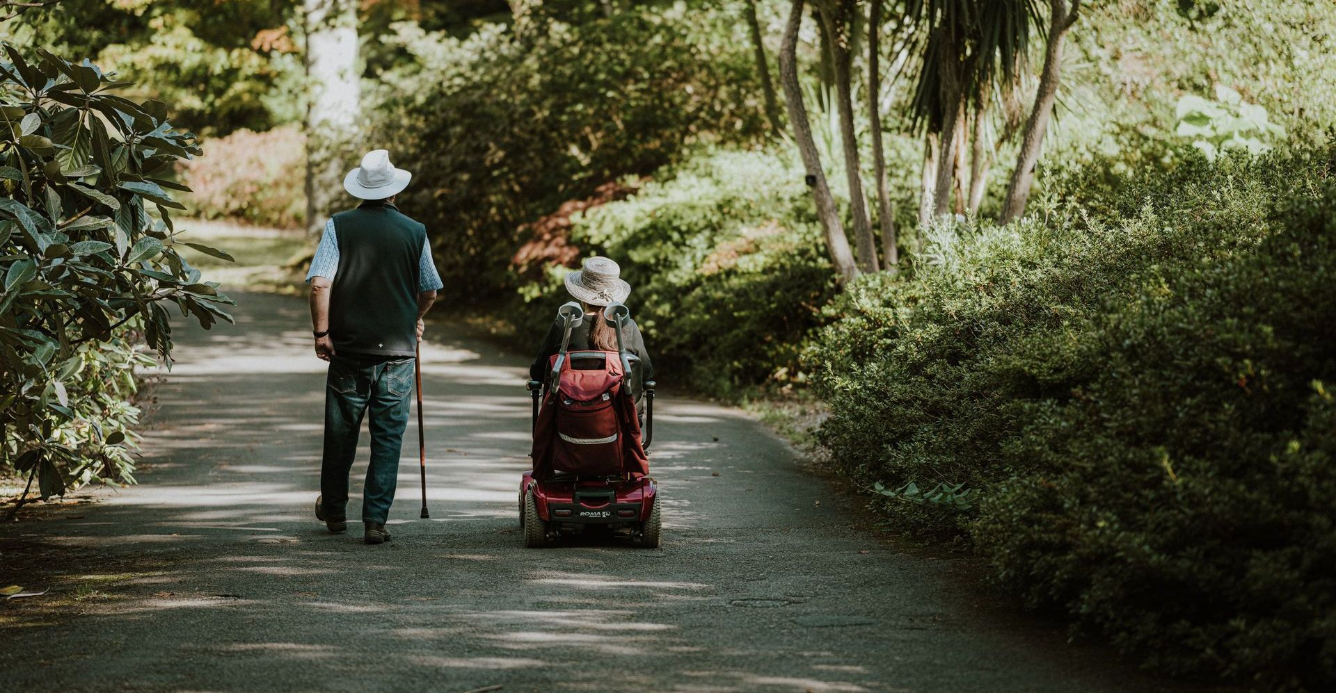 woman in wheelchair with man with cane