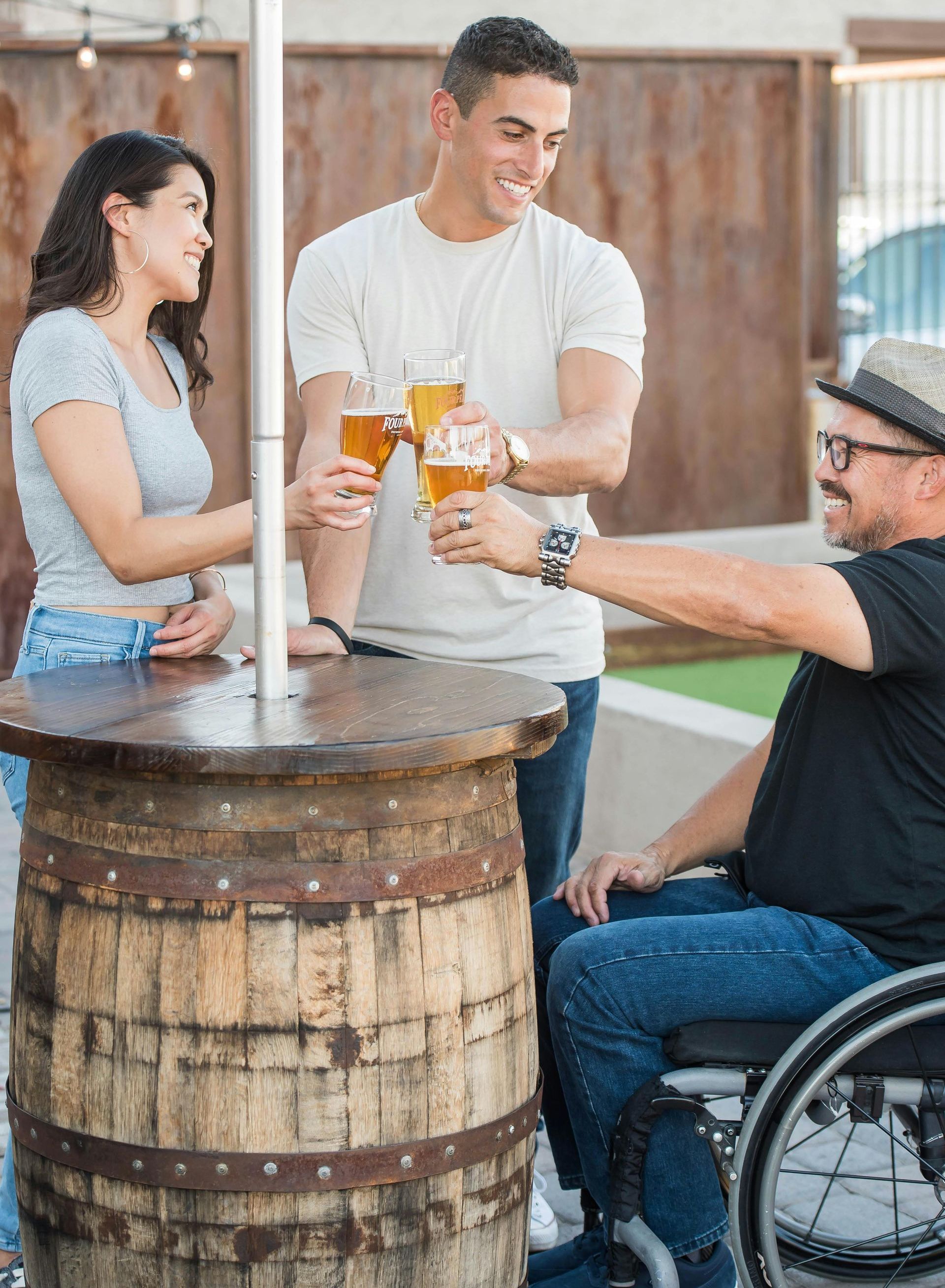 a man in a wheelchair is sitting at a table with two other people 