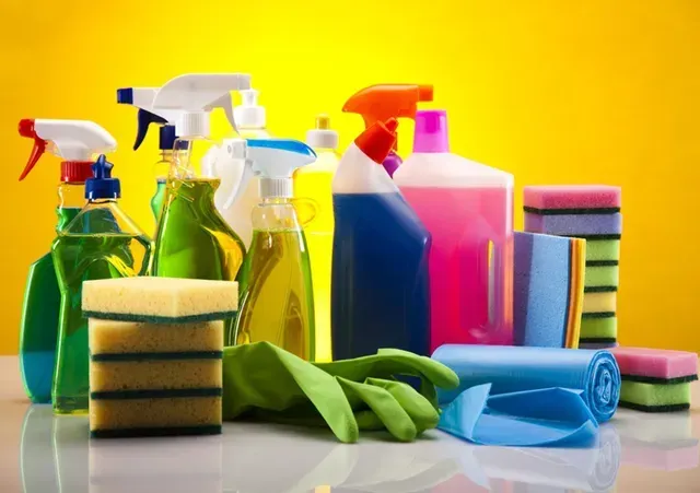 A bunch of cleaning supplies are sitting on a table.