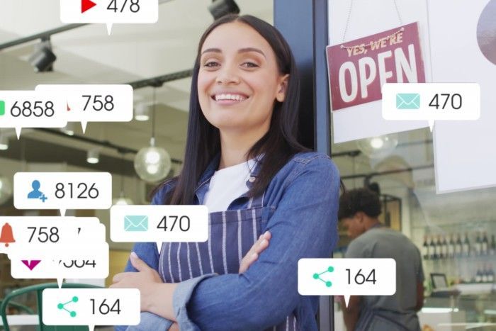 Woman in apron smiles outside a shop, surrounded by social media icons.