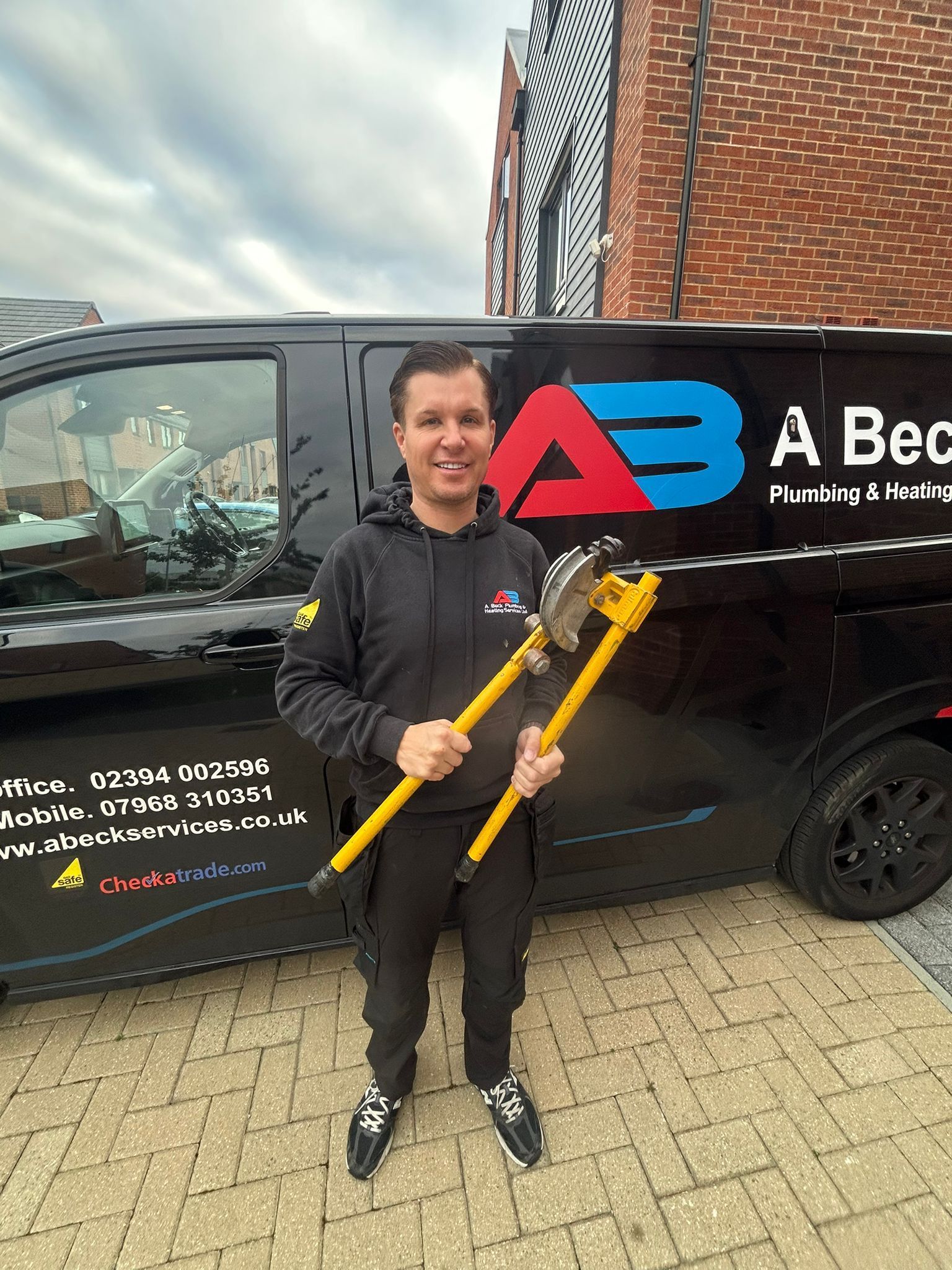 Andy Beck, standing in front of a van 