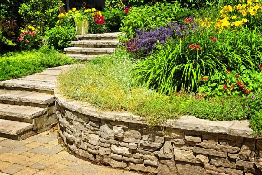 A Stone Wall in a Garden With Stairs and Flowers — Lakecrest Projects in Lake Macquarie, NSW