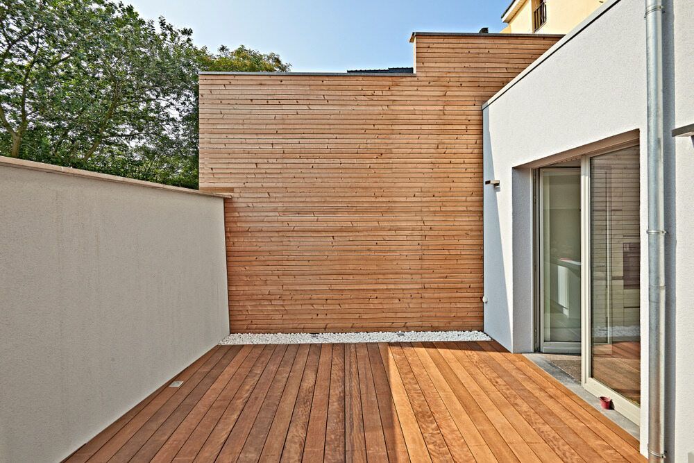 A Wooden Deck in Front of a White Building — Lakecrest Projects in Lake Macquarie, NSW