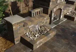 Brick water feature with waterfall and archway.