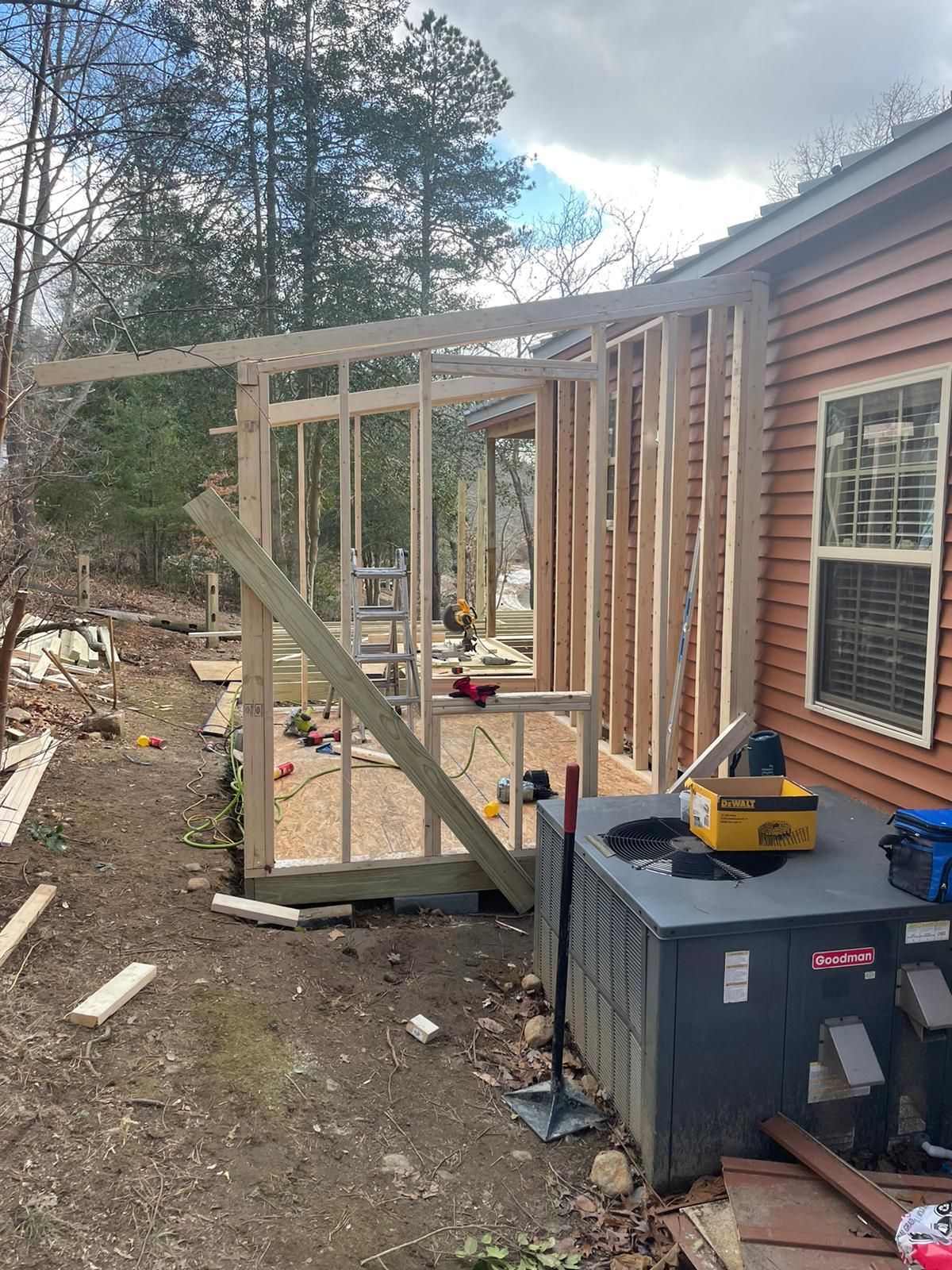 a mobile home is being remodeled with a porch being built .