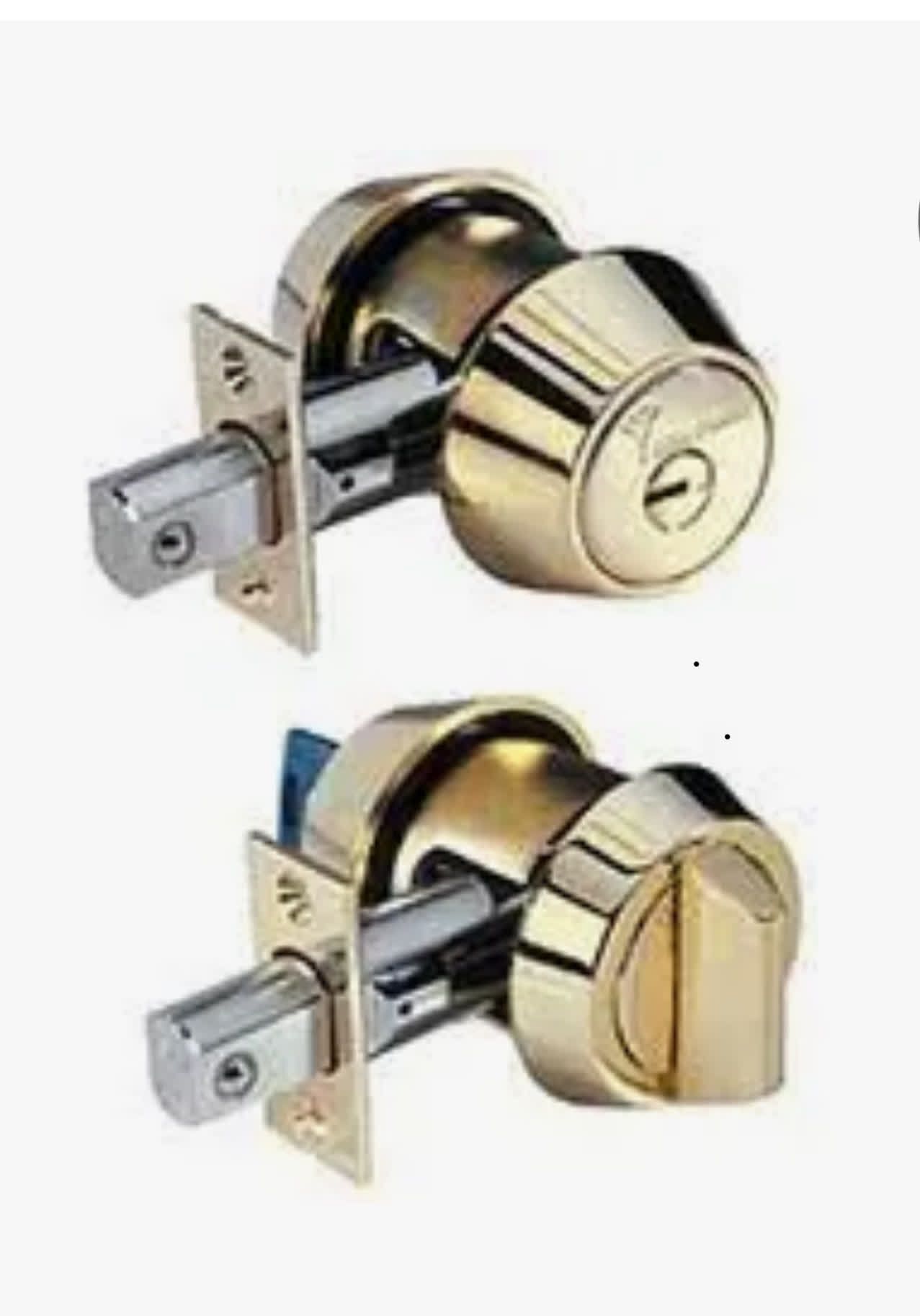 Two brass deadbolt door locks, one with keyhole, one with knob, mounted on door frame.