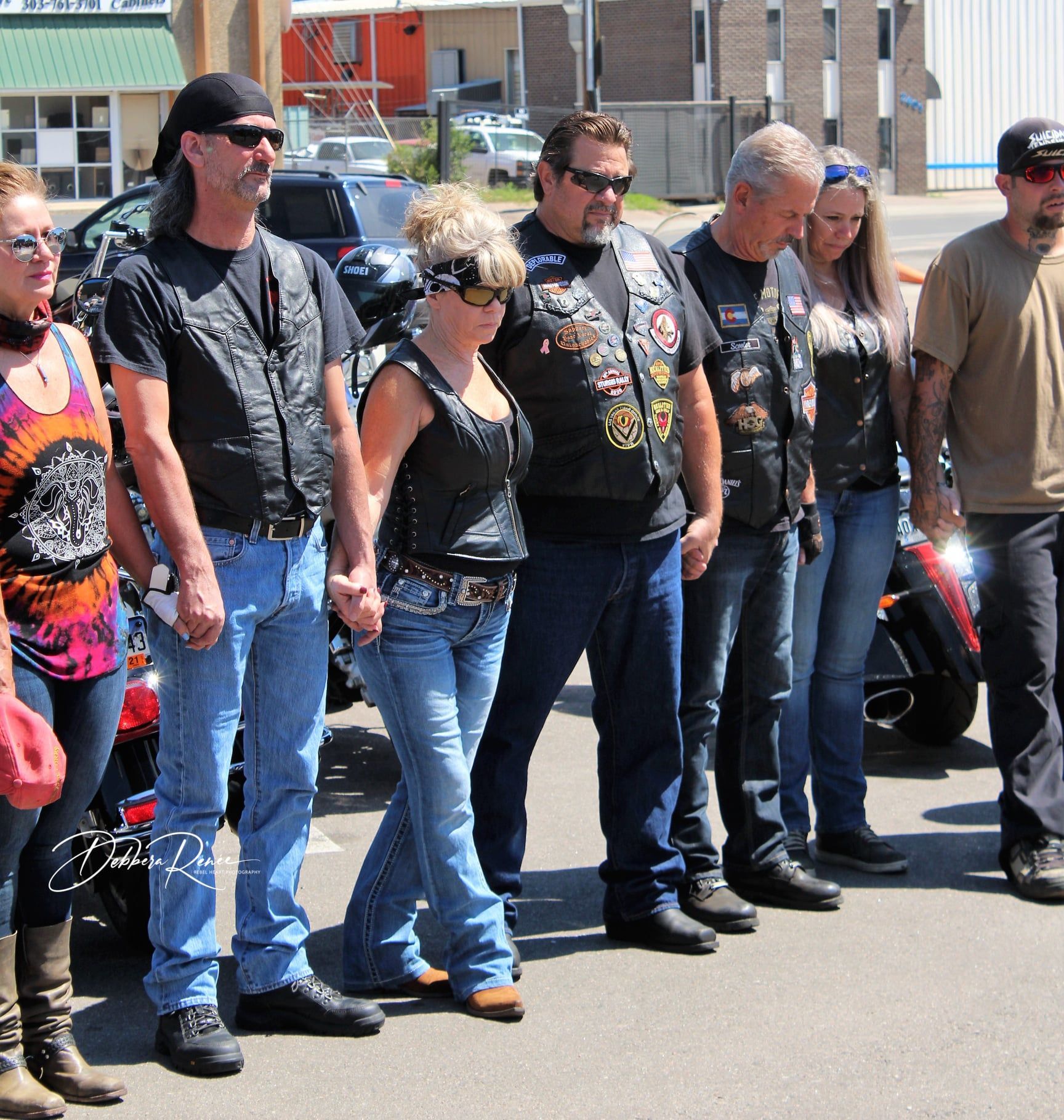 A group of people standing in front of a motorcycle