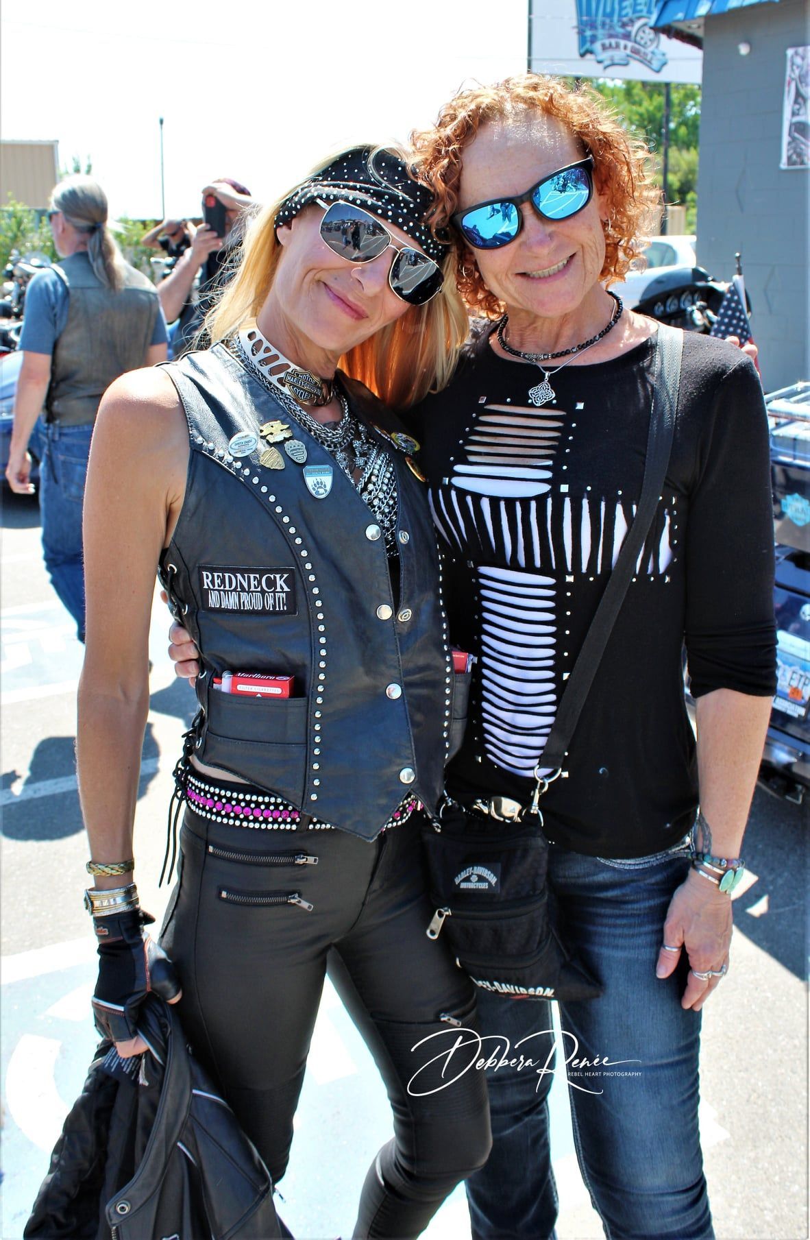 Two women are posing for a picture and one of them is wearing sunglasses