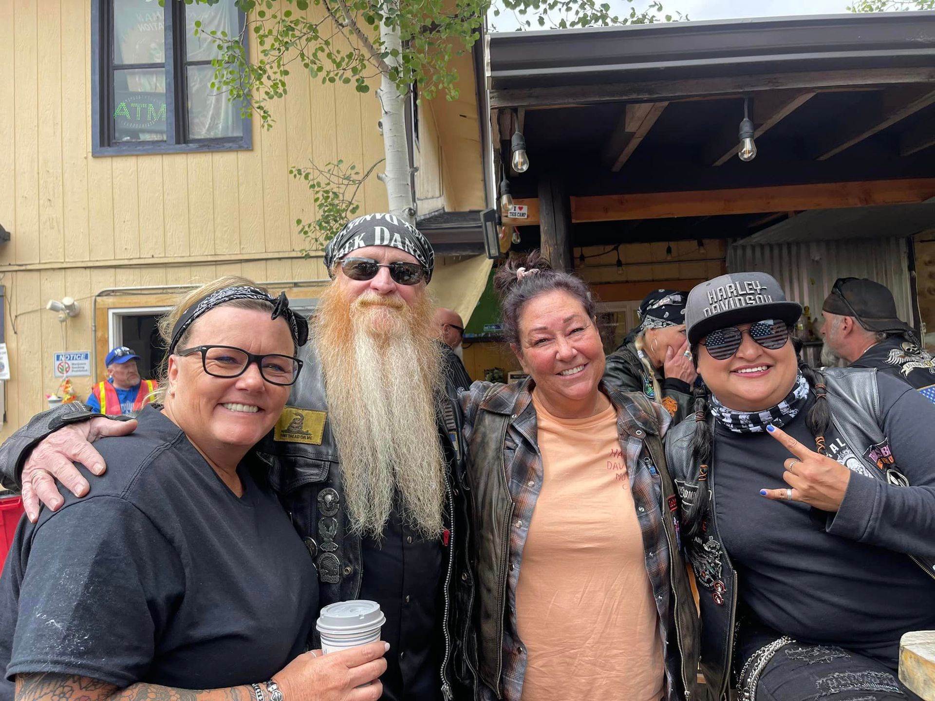 A group of people are posing for a picture in front of a building.