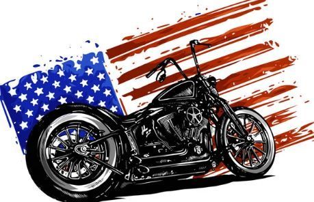 A motorcycle is parked in front of an american flag.