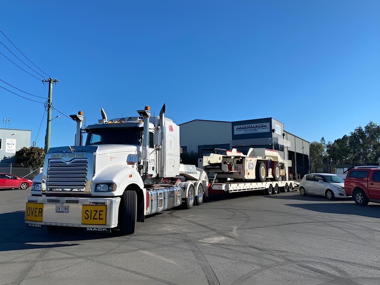 A Large Semi Truck Is Parked In A Parking Lot In Front Of A Building — Armour Transport Logistics In Rutherford, NSW