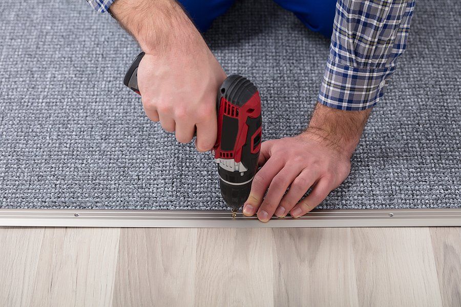 man installing a carpet