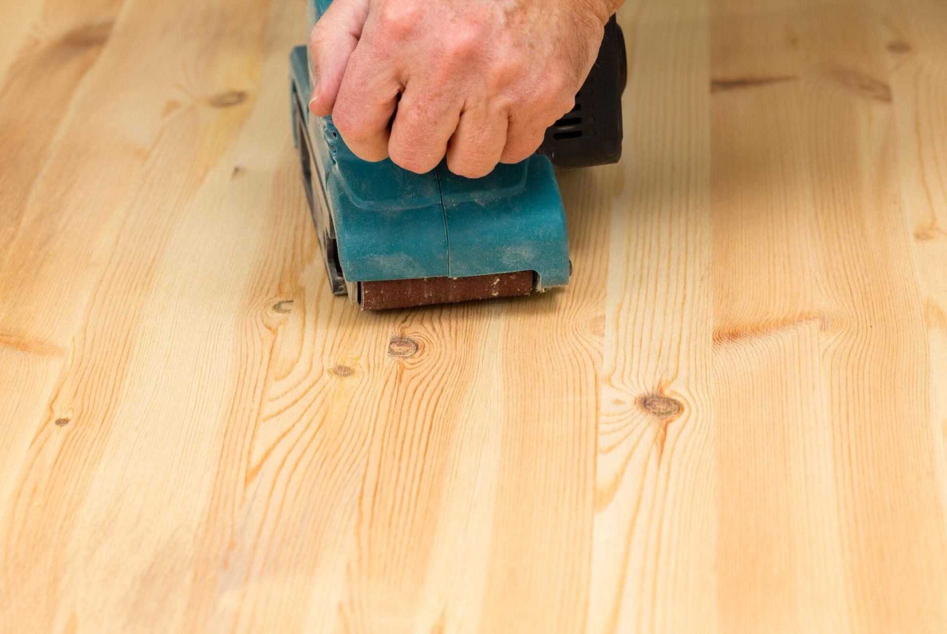 man polishing a wood tiles