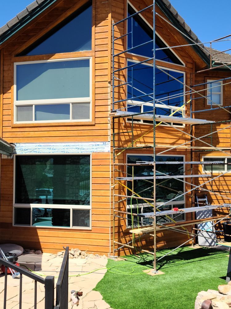 A large wooden house with a scaffolding in front of it